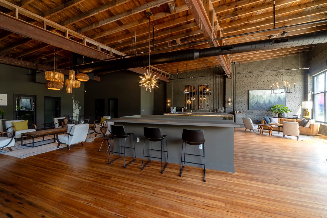 Main gathering space with exposed beams and bar seating